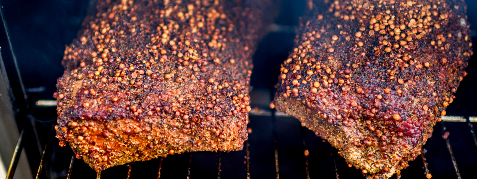 A imagem mostra peças de carne defumando com tempero em cima, ilustrando dry rub como usar.